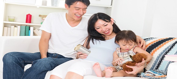 asian pregnant couple enjoying quality time with family